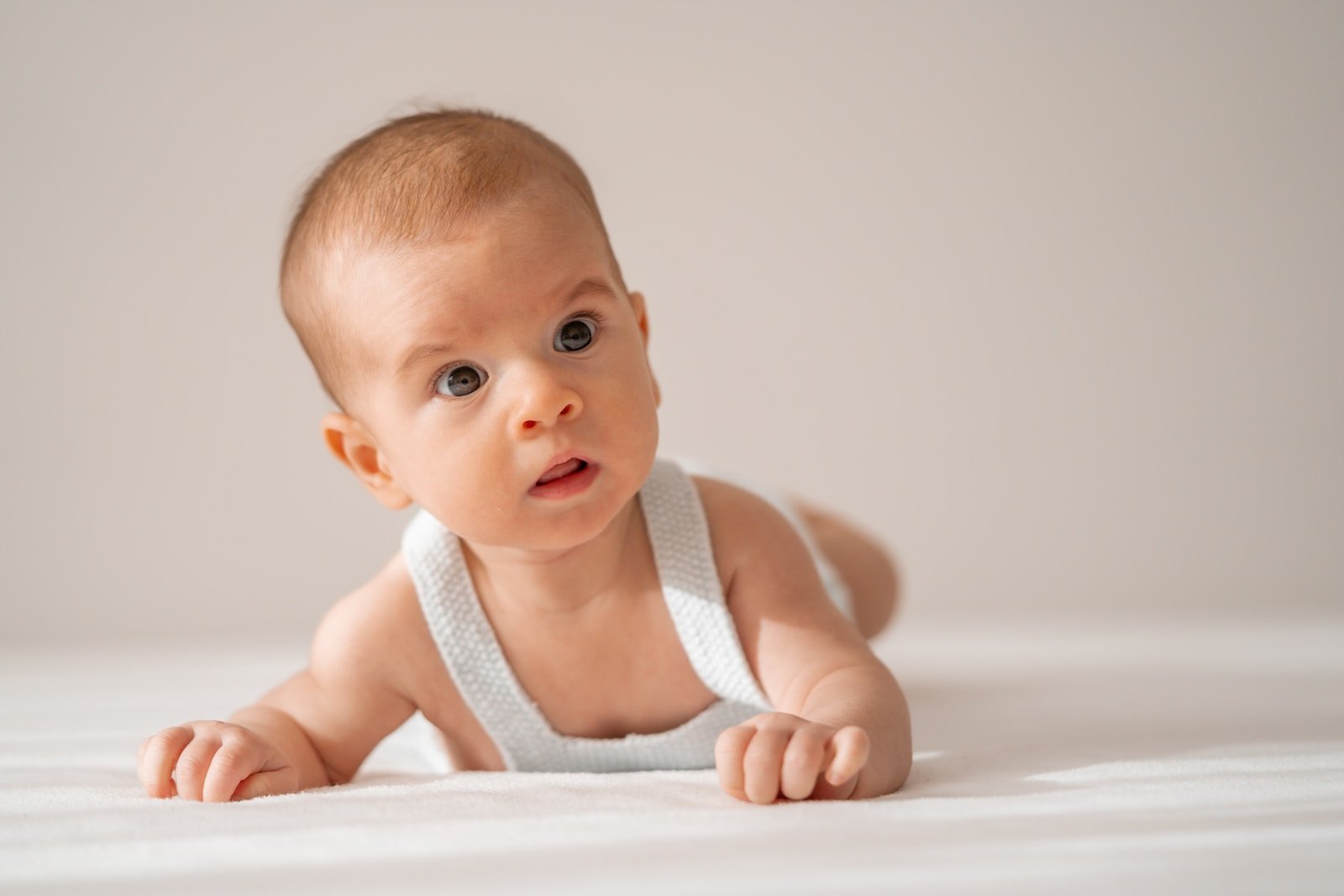 a baby in a diaper looking at the camera